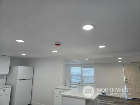 a kitchen with stainless steel appliances granite countertop a sink and a refrigerator