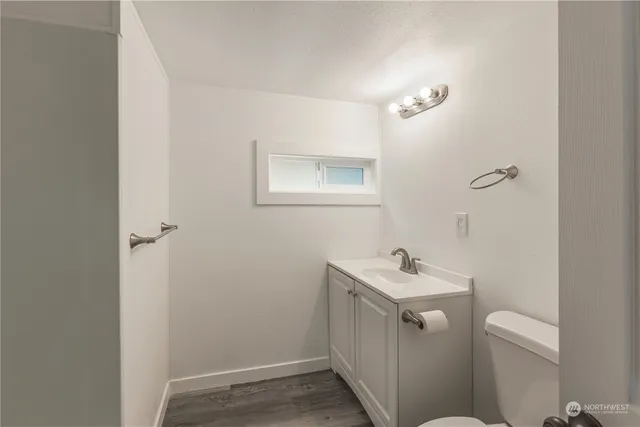 a bathroom with a sink toilet and a mirror