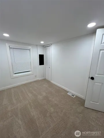 an empty room with a empty space and windows