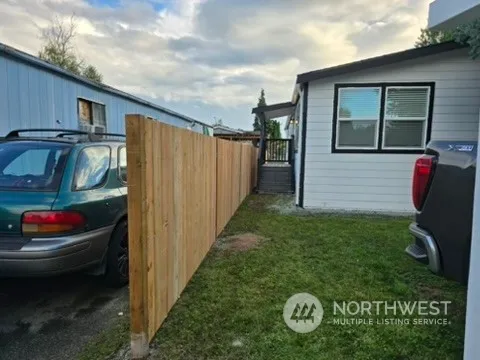 a backyard of a house with barbeque oven table and chairs