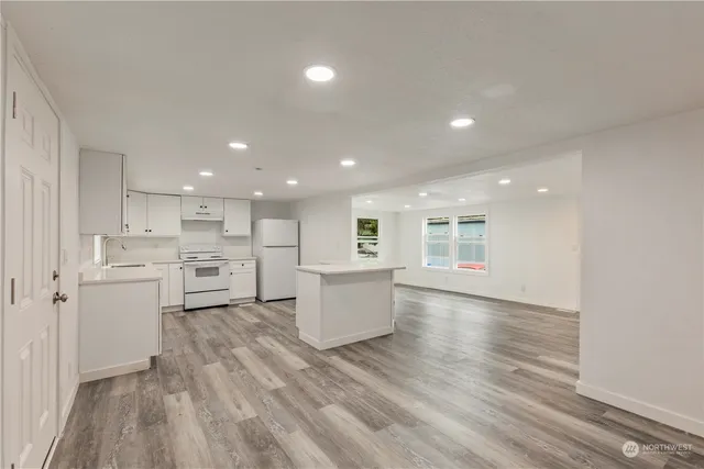 a view of kitchen with wooden floor and electronic appliances