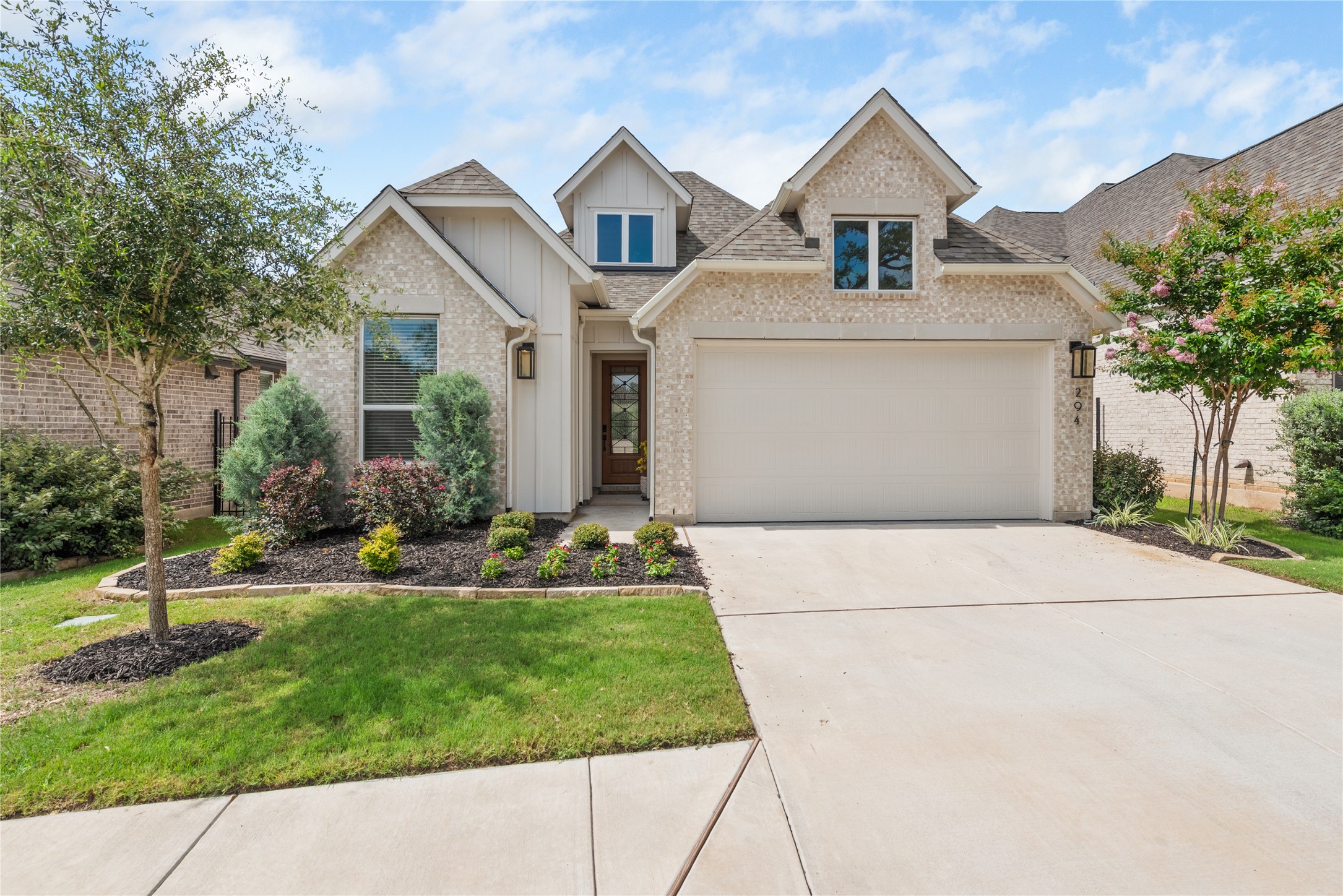 294 Kimble Creek Loop Kyle, TX 78640 - Photo 12 of 40 A charming single-family home with an attached garage and well-maintained front yard landscaping.