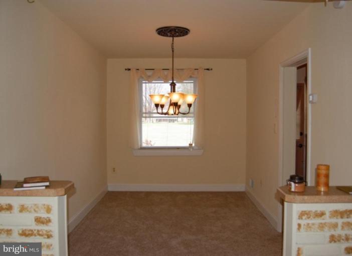 7942 Kavanagh Road Dundalk, MD 21222 - Photo 3 of 11 a room with window and chandelier