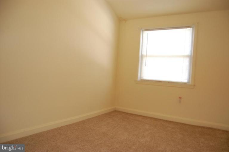 7942 Kavanagh Road Dundalk, MD 21222 - Photo 4 of 11 an empty room with a window