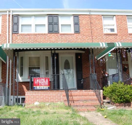 7942 Kavanagh Road Dundalk, MD 21222 - Photo 7 of 11 a front view of a building with a garden