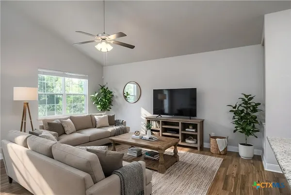 a living room with furniture and a flat screen tv