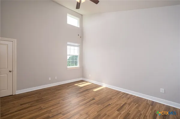 wooden floor in an empty room with a window