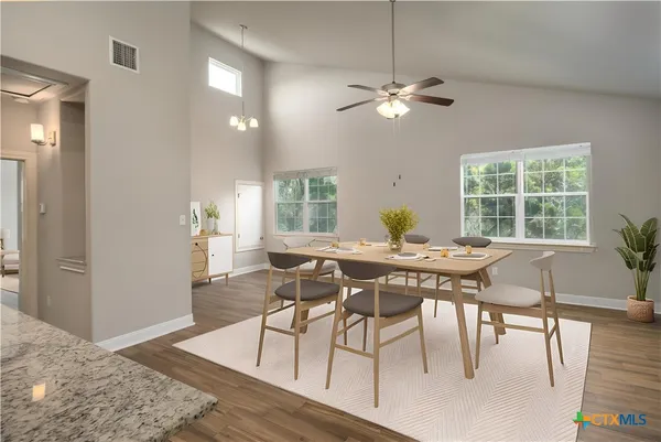 a view of a dining room with furniture window and wooden floor