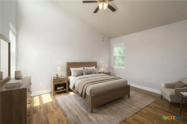 a bedroom with a bed and wooden floor