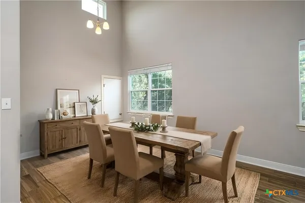 a dining room with furniture and window