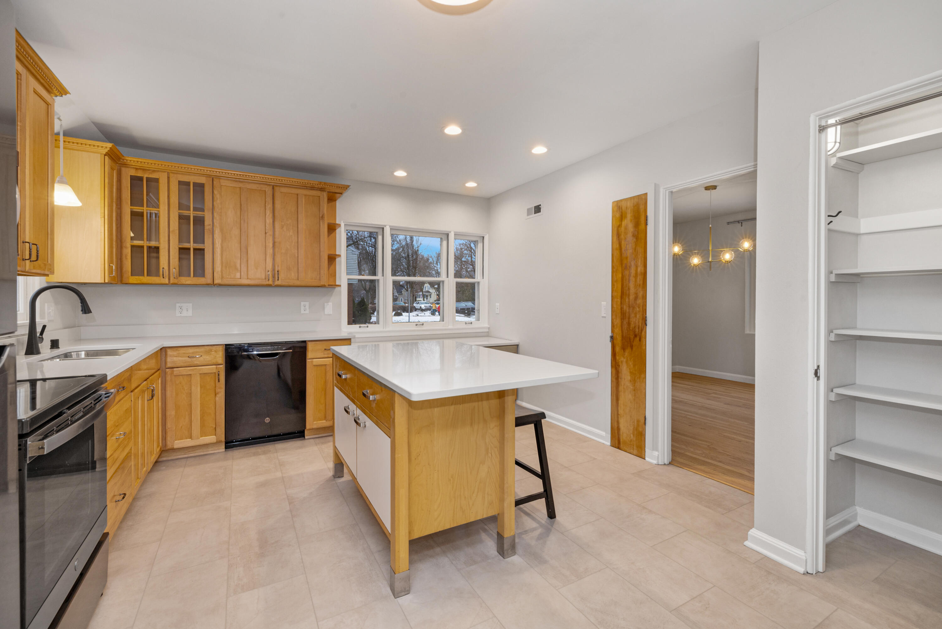 5873 North Santa Monica Boulevard Whitefish Bay, WI 53217 - Photo 6 of 22 New Quartz countertops and island! Soft close door hinges on cabinetry.