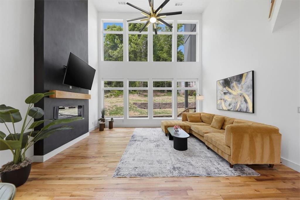 4107 Danforth Road Southwest Atlanta, GA 30331 - Photo 13 of 64 a living room with furniture a flat screen tv and a floor to ceiling window