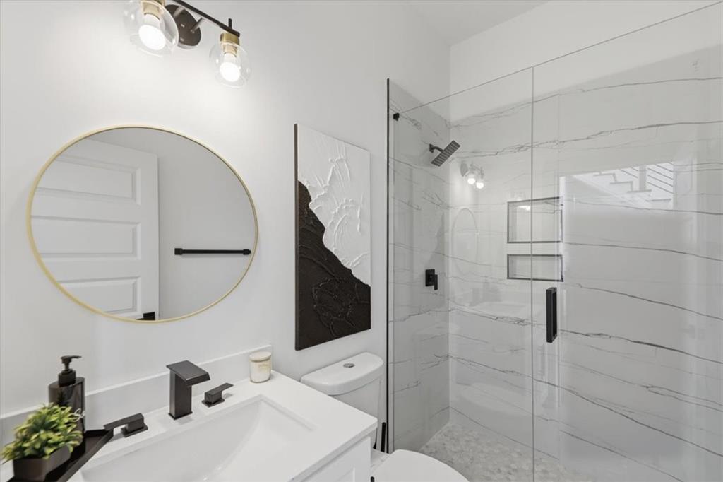 4107 Danforth Road Southwest Atlanta, GA 30331 - Photo 25 of 64 a bathroom with a sink a toilet and a mirror