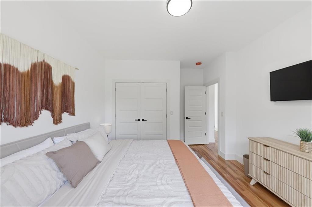 4107 Danforth Road Southwest Atlanta, GA 30331 - Photo 30 of 64 a spacious bedroom with a bed and a flat screen tv