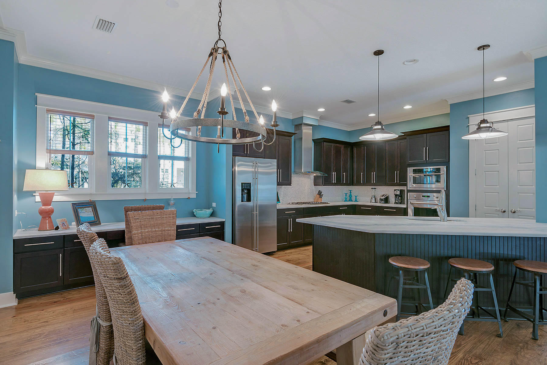 379 East Royal Fern Way Santa Rosa Beach, FL 32459 - Photo 18 of 53 a kitchen with stainless steel appliances granite countertop a kitchen island a stove a table and chairs in it