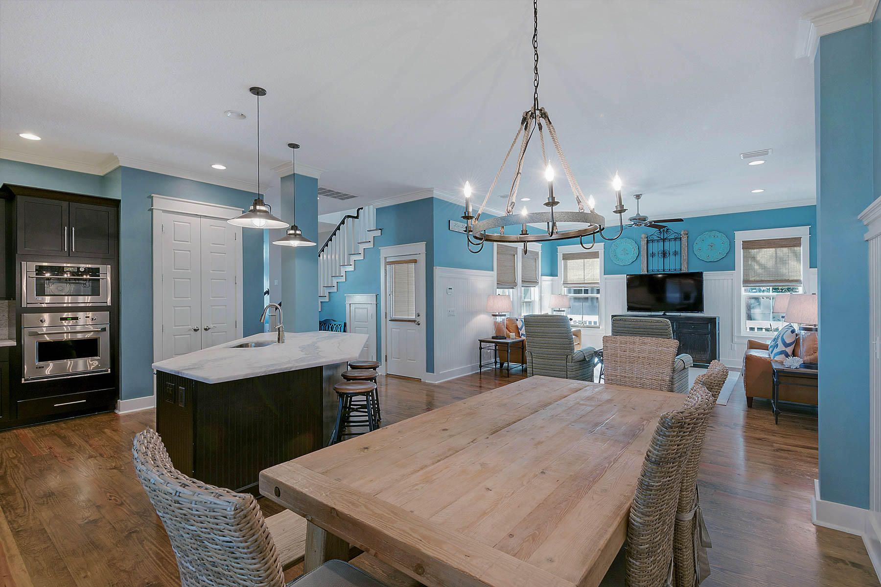 379 East Royal Fern Way Santa Rosa Beach, FL 32459 - Photo 19 of 53 a dining room with stainless steel appliances kitchen island granite countertop a refrigerator a stove a oven and a dining table with wooden floor