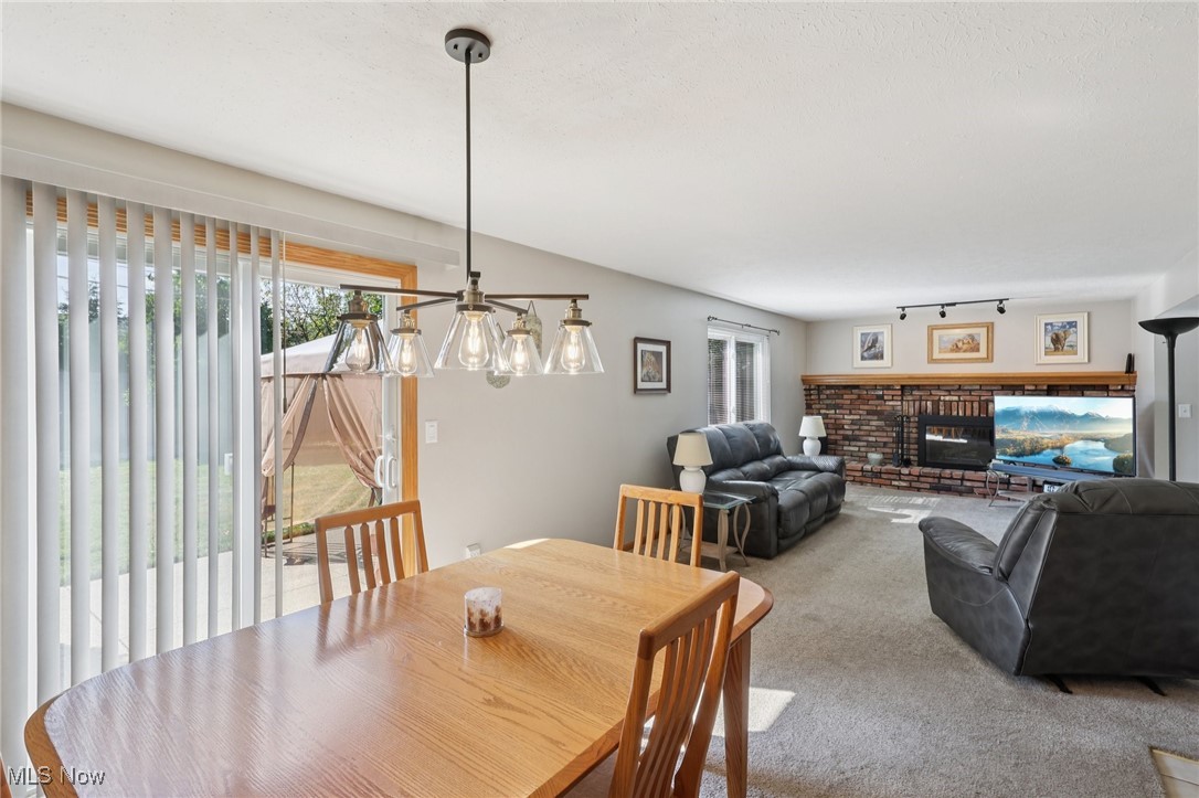 5877 Pearl Road Cleveland, OH 44130 - Photo 11 of 42 Carpeted dining area featuring a fireplace