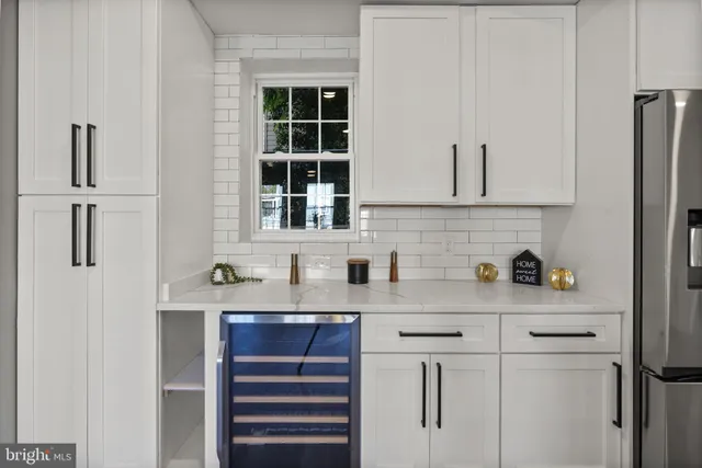 a kitchen with stainless steel appliances a refrigerator and cabinets