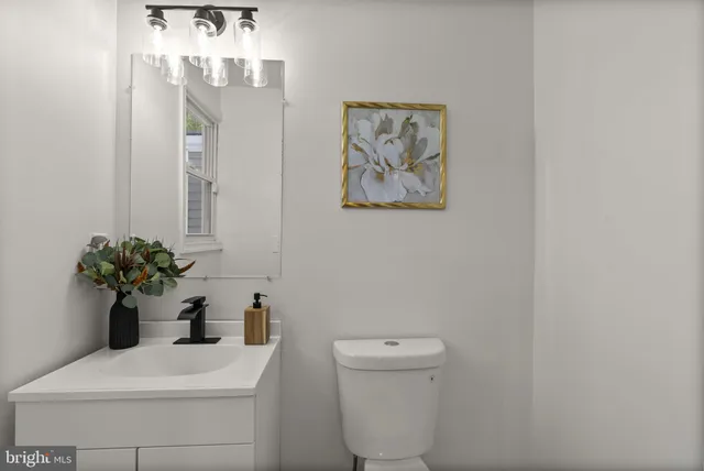 a view of an empty room with wooden floor and stairs