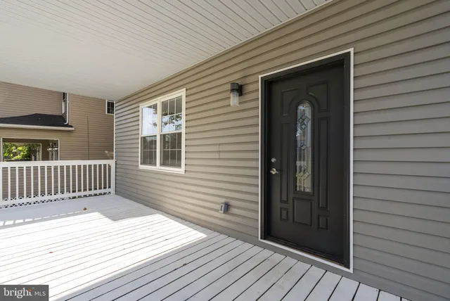 a view of a house with wooden deck