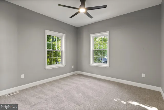 a bedroom with a bed and a ceiling fan