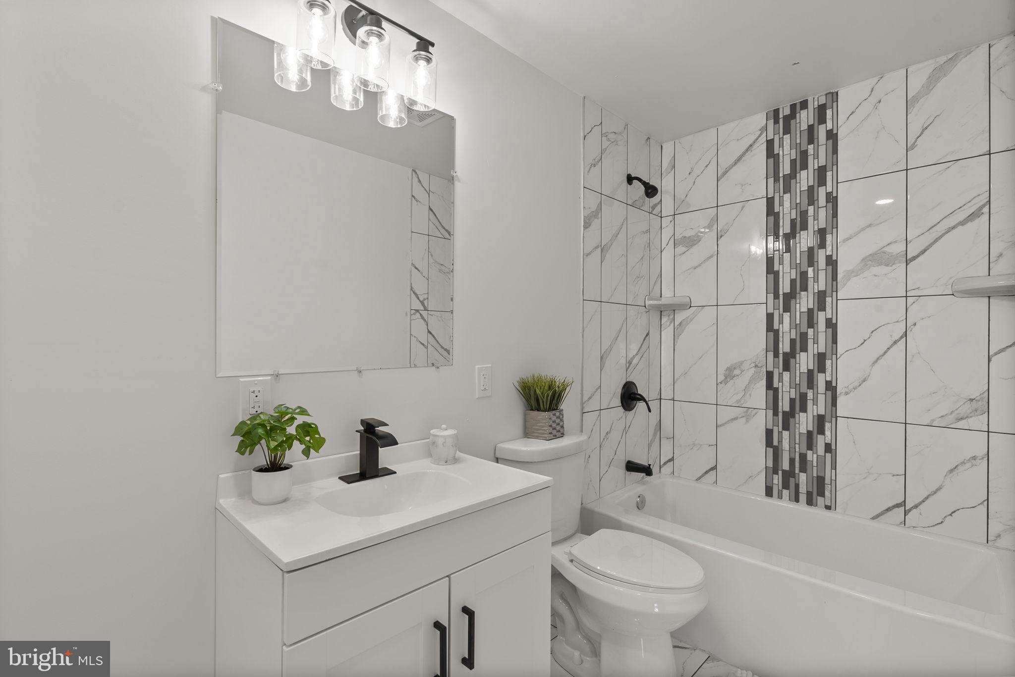 3417 Springdale Avenue Baltimore, MD 21216 - Photo 31 of 60 a bathroom with a sink toilet and shower