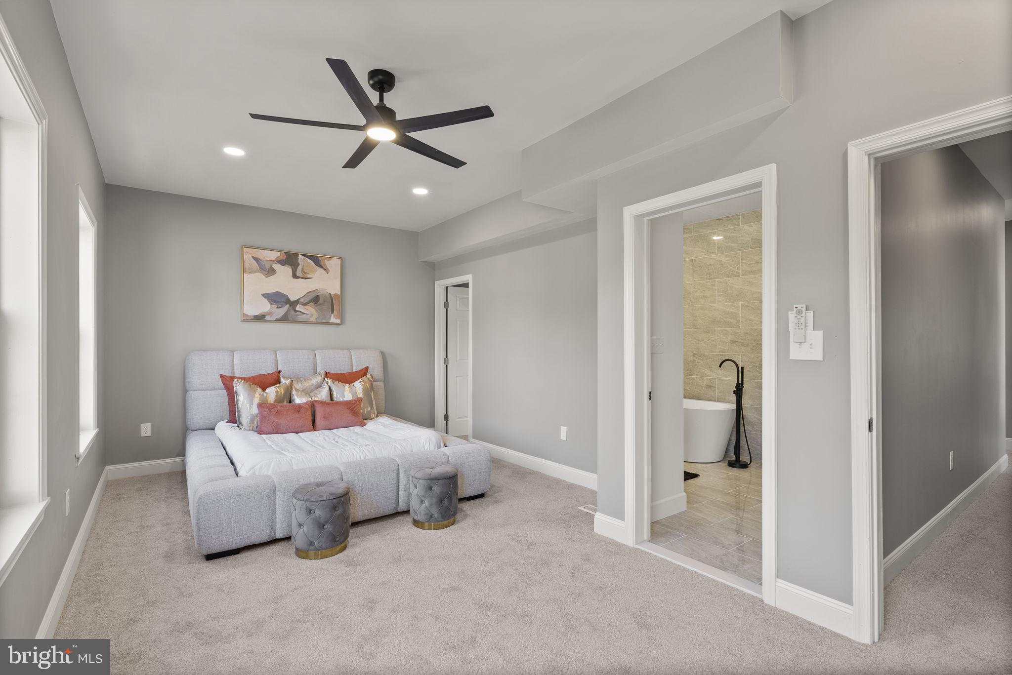 3417 Springdale Avenue Baltimore, MD 21216 - Photo 33 of 60 a bedroom with a bed and a ceiling fan