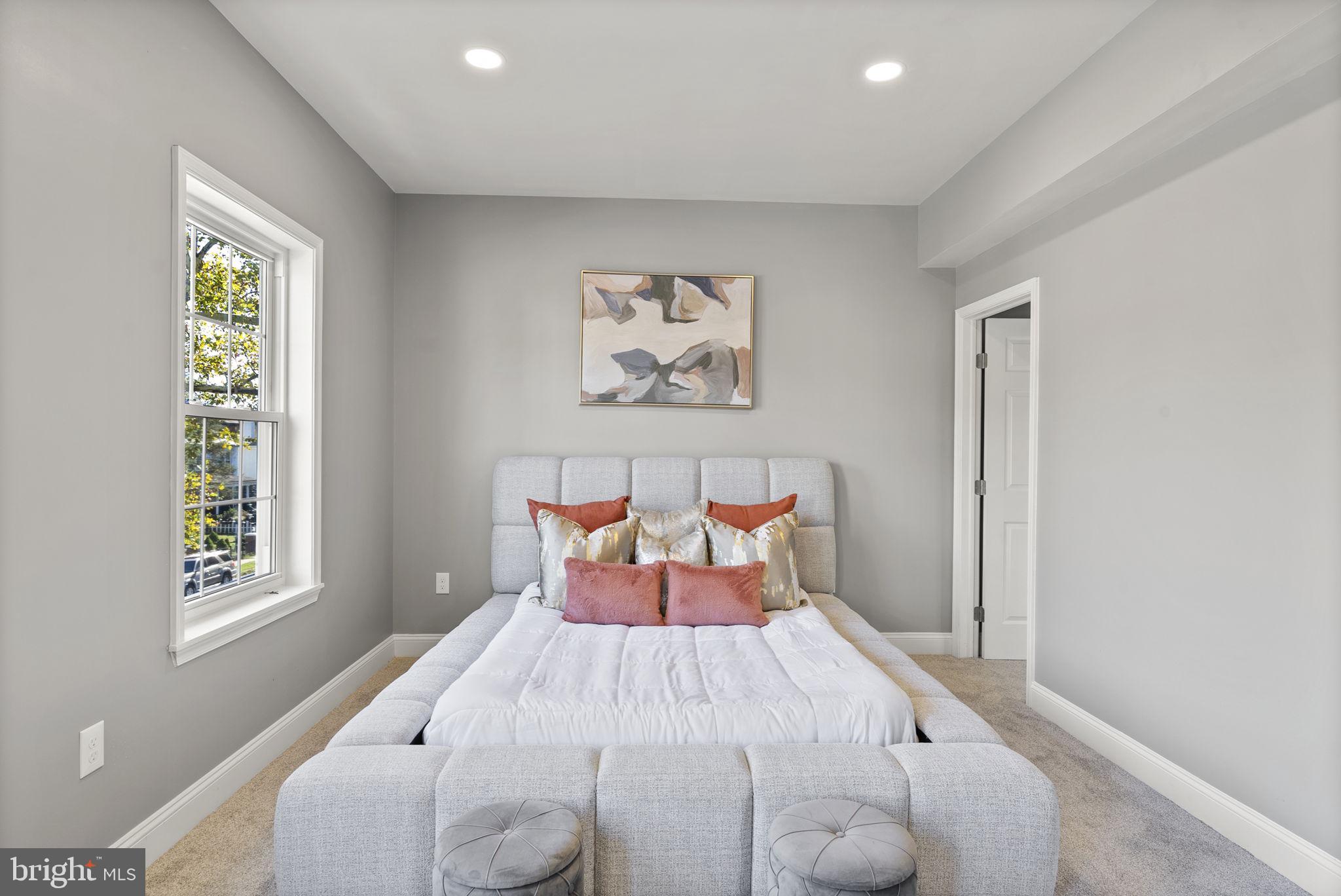 3417 Springdale Avenue Baltimore, MD 21216 - Photo 34 of 60 a bed sitting in a bedroom next to a window