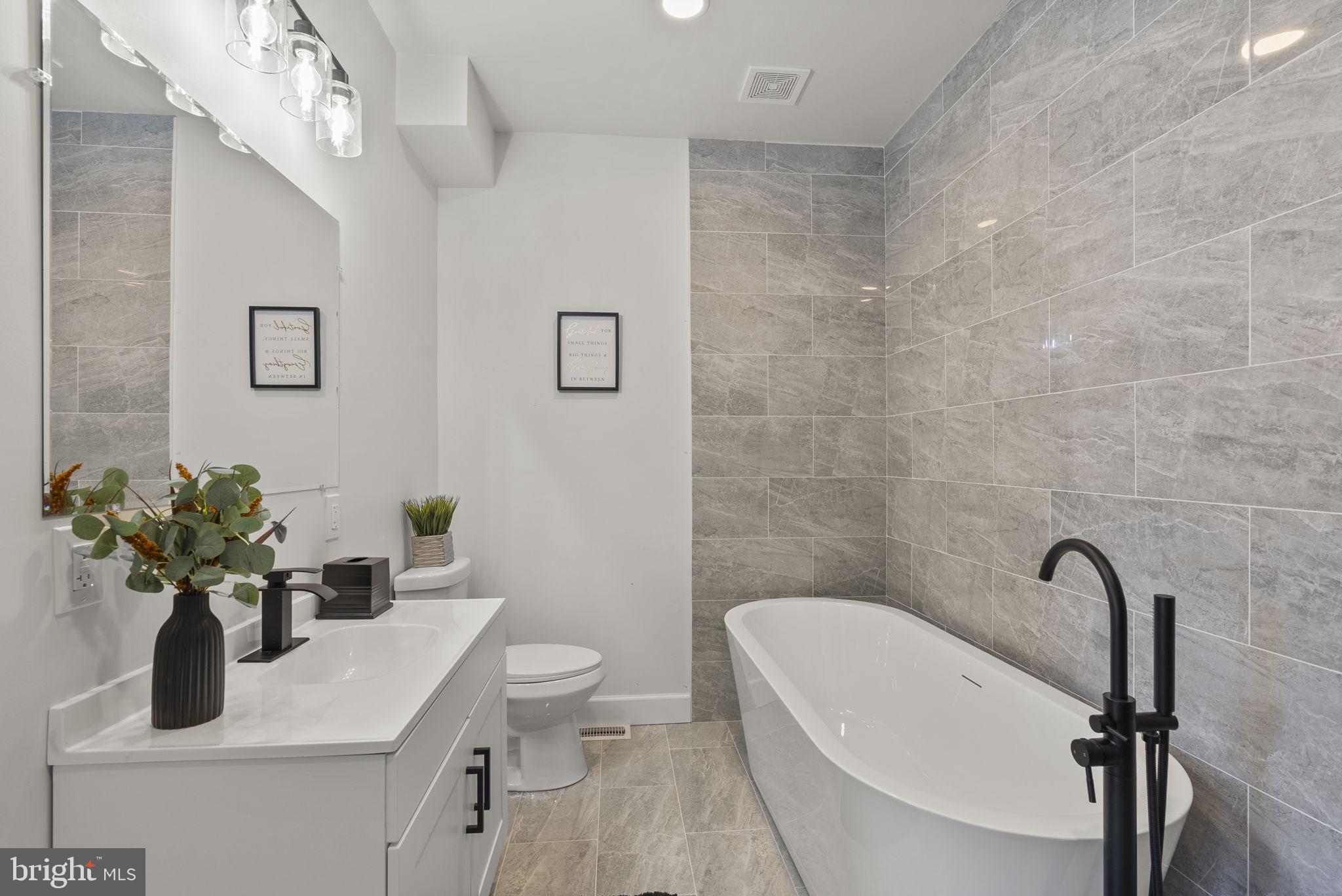 3417 Springdale Avenue Baltimore, MD 21216 - Photo 36 of 60 a bathroom with a sink a toilet and a mirror