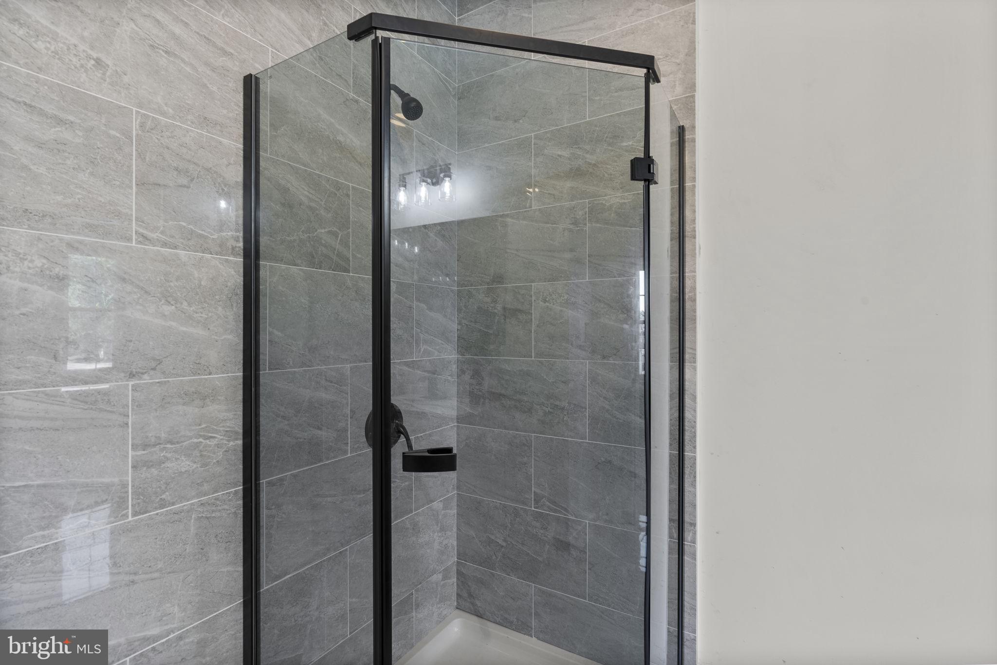 3417 Springdale Avenue Baltimore, MD 21216 - Photo 38 of 60 a bathroom with a glass shower door