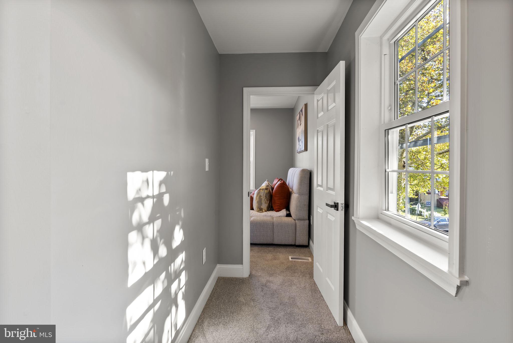3417 Springdale Avenue Baltimore, MD 21216 - Photo 42 of 60 a view of hallway with furniture and a large window