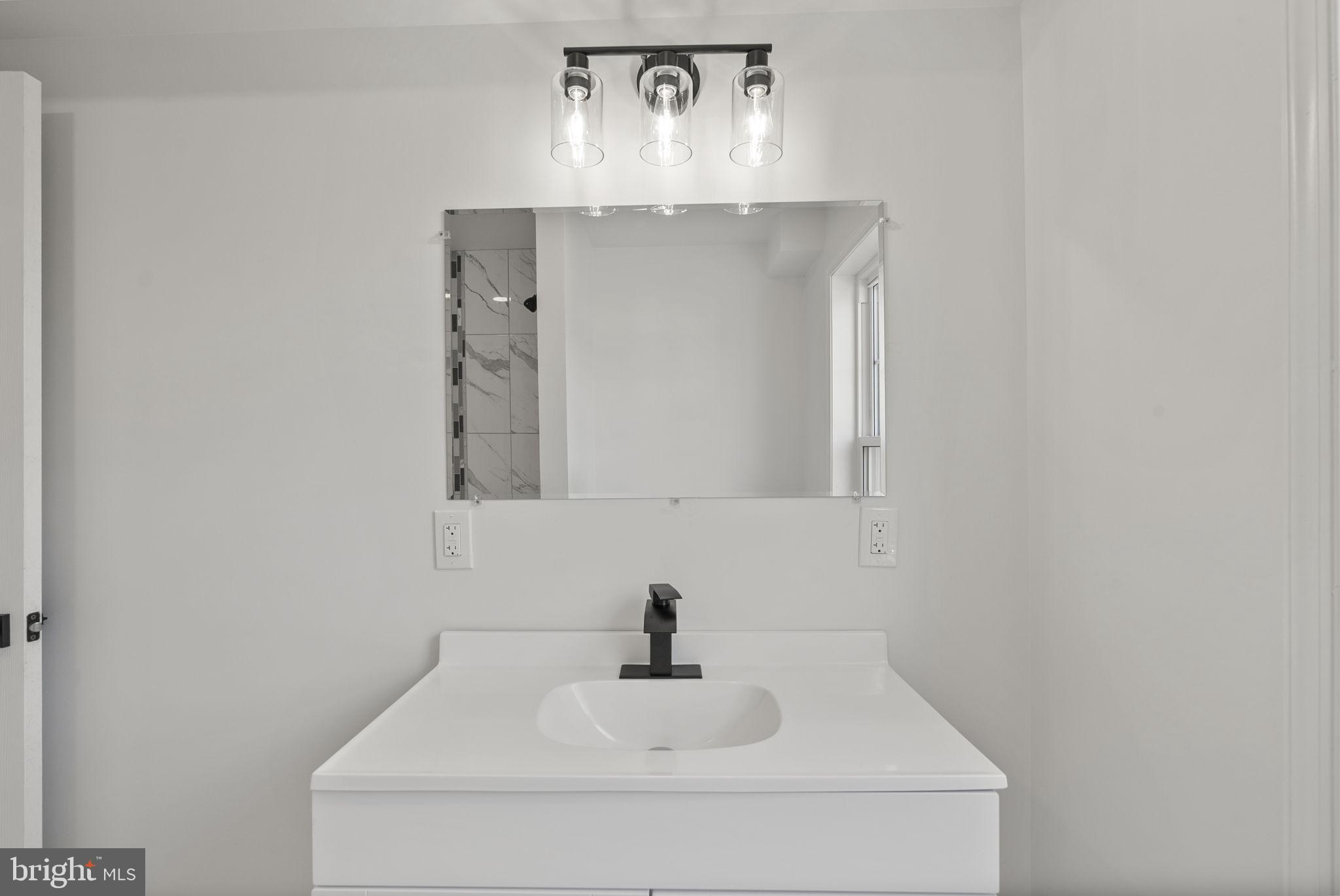 3417 Springdale Avenue Baltimore, MD 21216 - Photo 49 of 60 a bathroom with a sink and a mirror