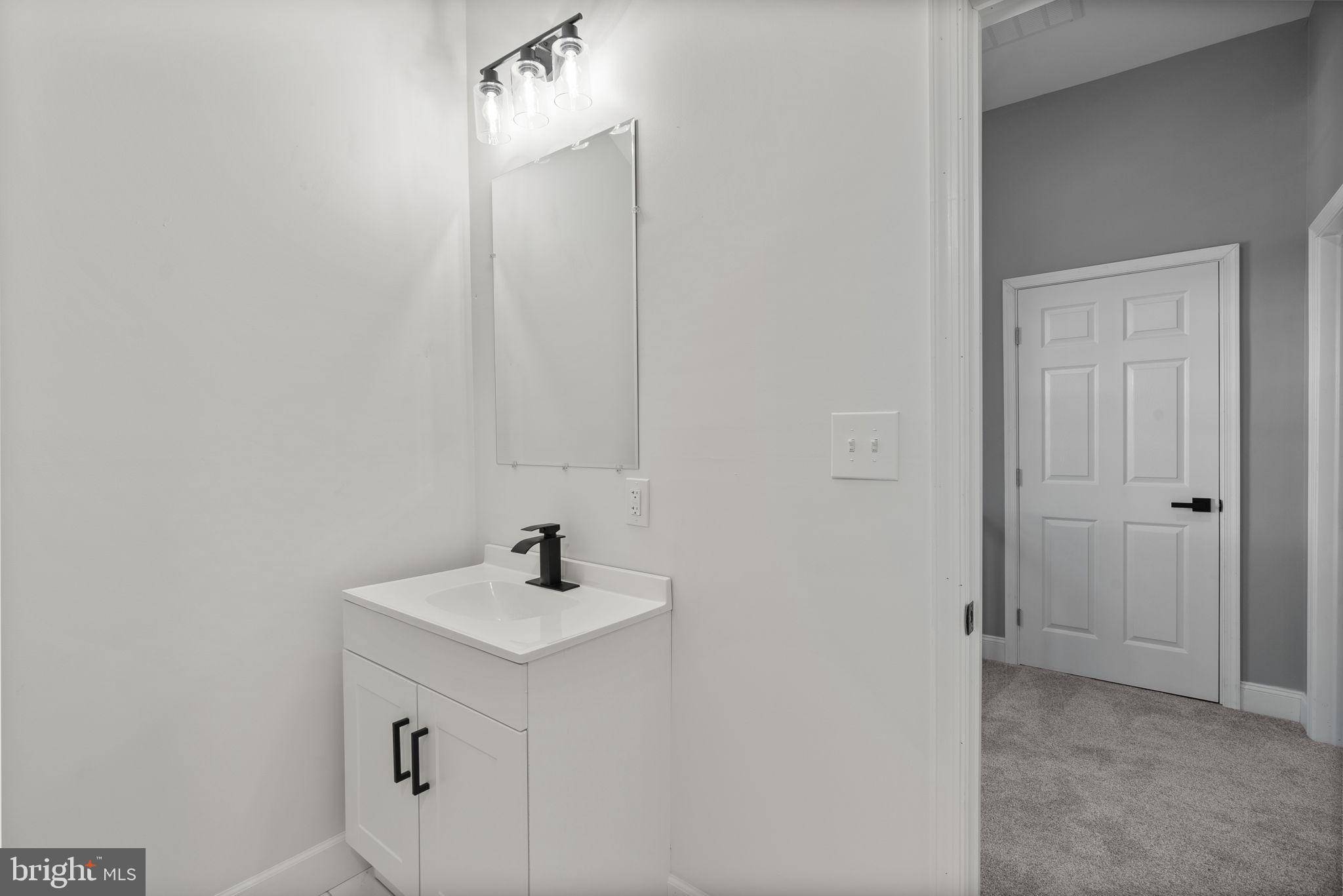3417 Springdale Avenue Baltimore, MD 21216 - Photo 54 of 60 a bathroom with a sink and a mirror