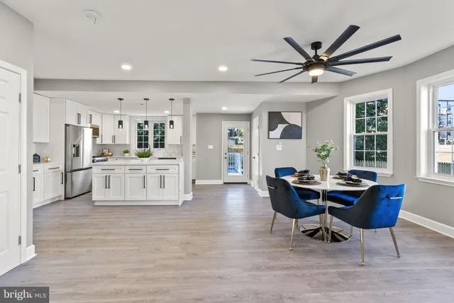 a view of a dining room with furniture and a window