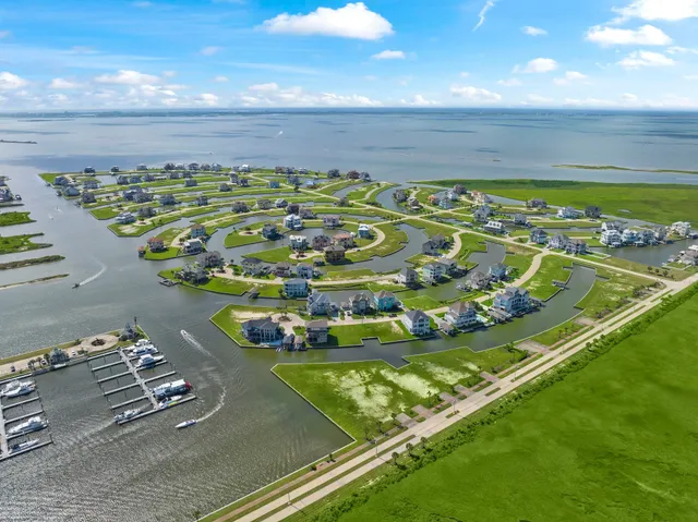 a view of a pool a building and outdoor seating