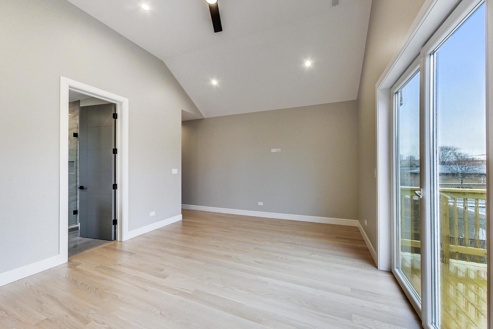 4745 South Indiana Avenue, Unit 3 Chicago, IL 60615 - Photo 36 of 42 an empty room with wooden floor and windows