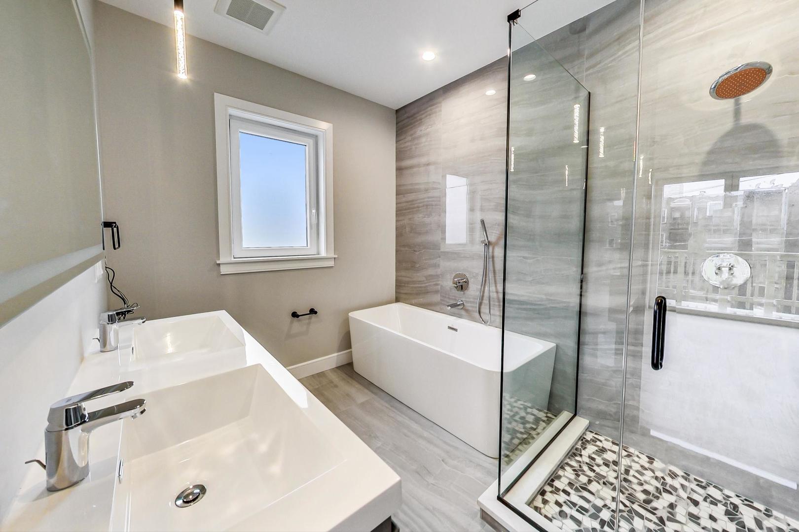 4745 South Indiana Avenue, Unit 3 Chicago, IL 60615 - Photo 38 of 42 a bathroom with a tub sink and mirror