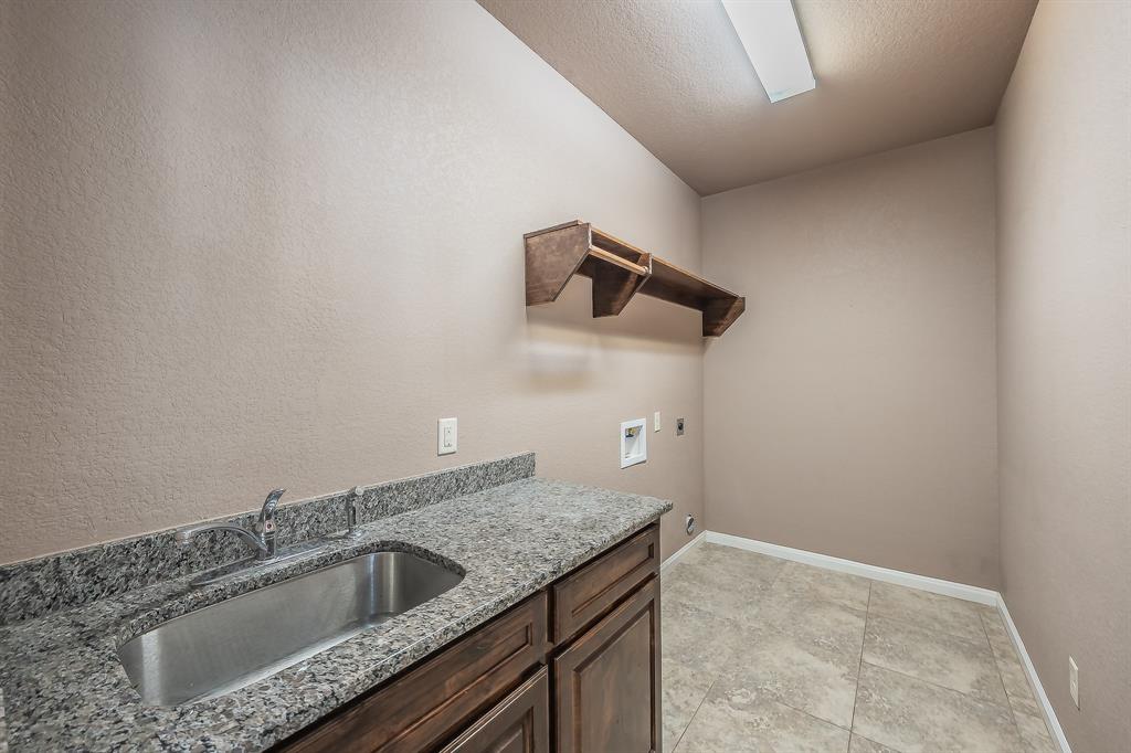 405 Edgewood Terrace Boyd, TX 76023 - Photo 21 of 39 a bathroom with a granite countertop sink and vanity