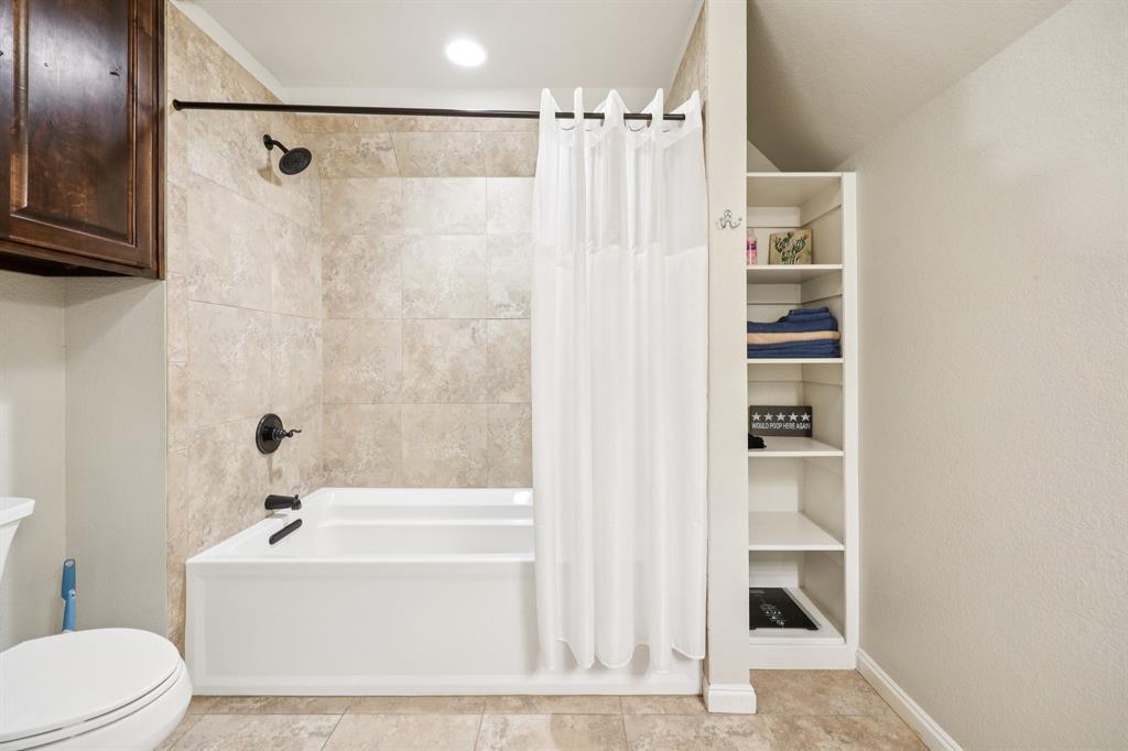 405 Edgewood Terrace Boyd, TX 76023 - Photo 24 of 39 a bathroom with a bathtub and a shower