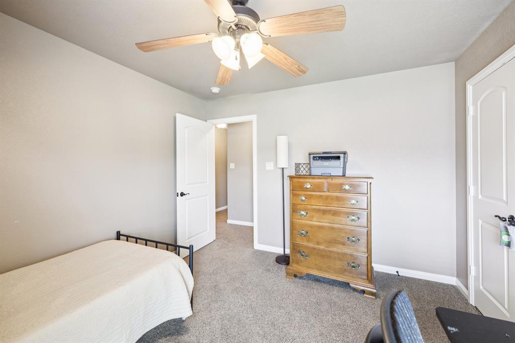 405 Edgewood Terrace Boyd, TX 76023 - Photo 29 of 39 a bedroom with a bed and a ceiling fan