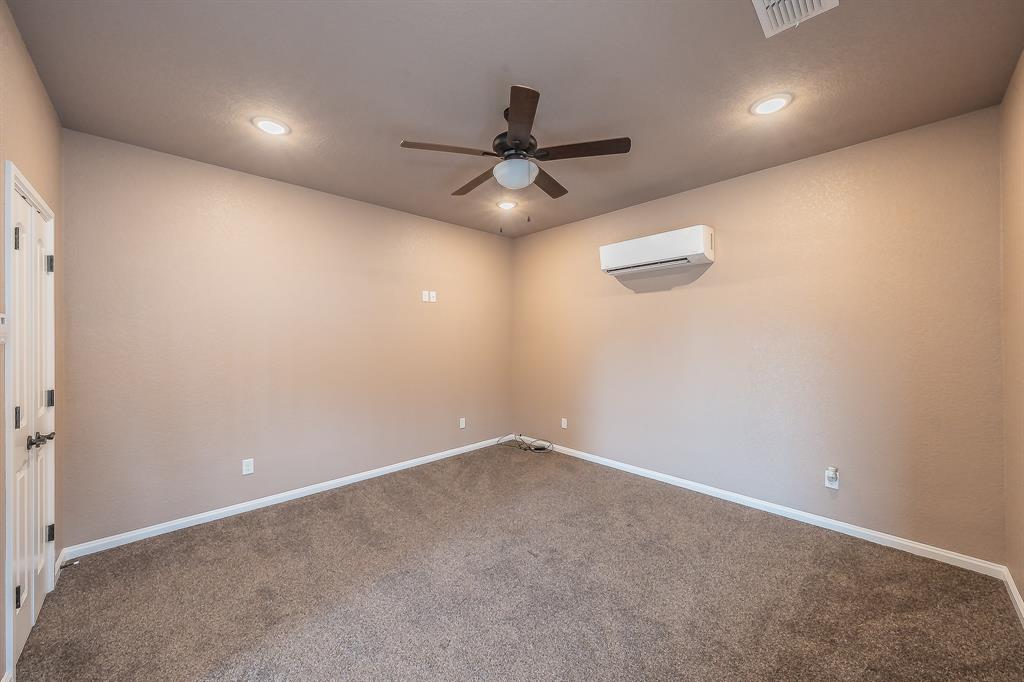 405 Edgewood Terrace Boyd, TX 76023 - Photo 34 of 39 an empty room with a ceiling fan and window