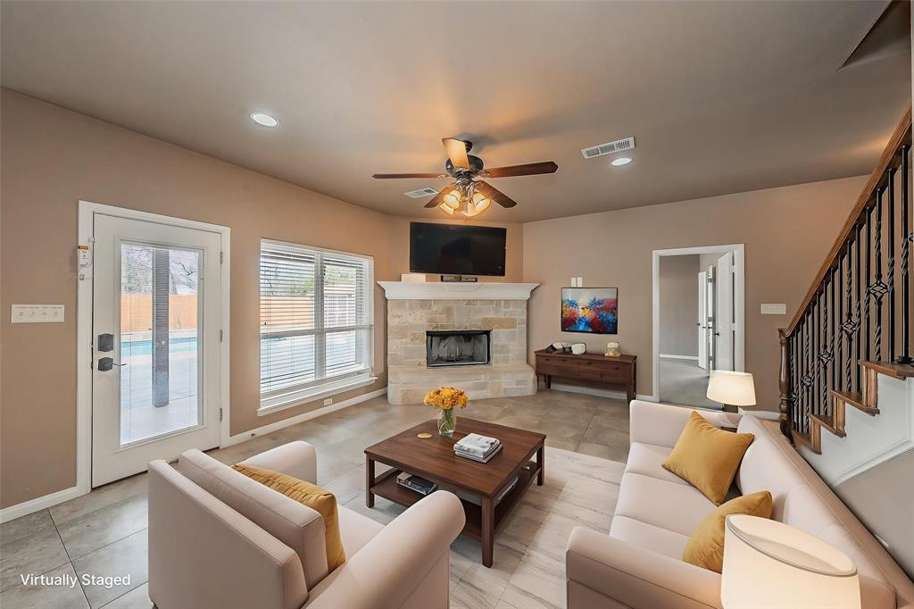 405 Edgewood Terrace Boyd, TX 76023 - Photo 8 of 39 a living room with furniture a fireplace and a flat screen tv