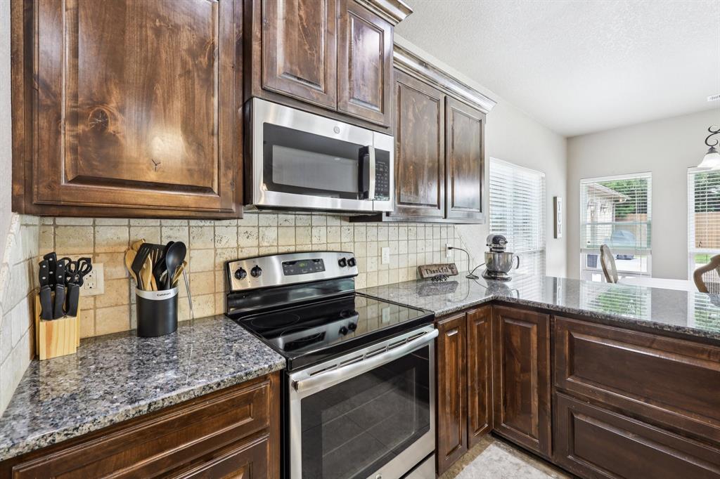 405 Edgewood Terrace Boyd, TX 76023 - Photo 10 of 39 a kitchen with a sink stove and microwave