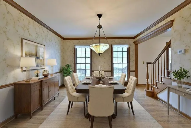 a view of an empty room with wooden floor and fan