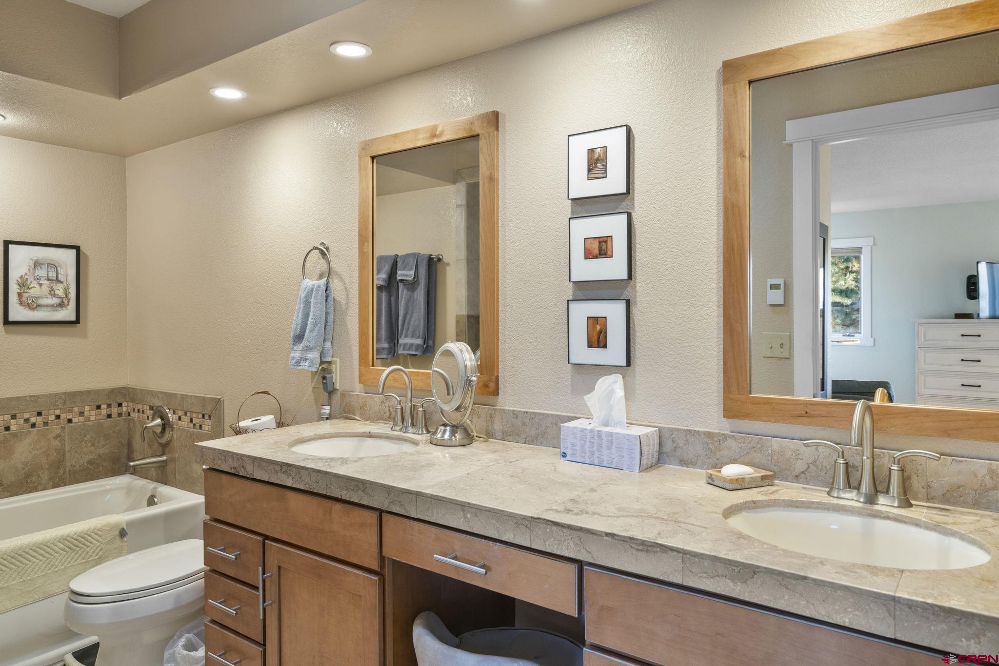 321 Pine Ridge Loop Durango, CO 81301 - Photo 16 of 35 a bathroom with a granite countertop sink double vanity and a mirror