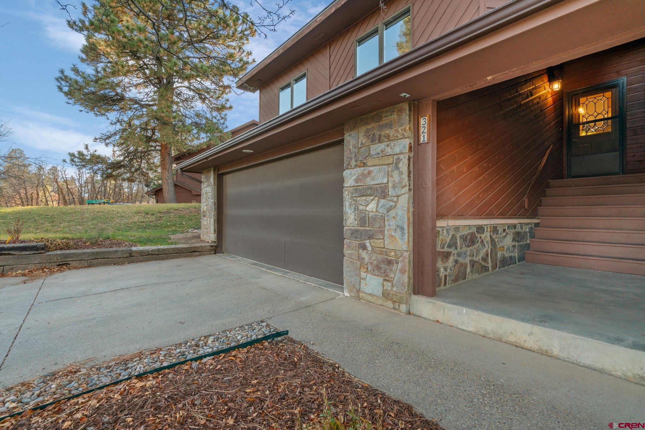 321 Pine Ridge Loop Durango, CO 81301 - Photo 30 of 35 a brick building with a large parking space near a yard