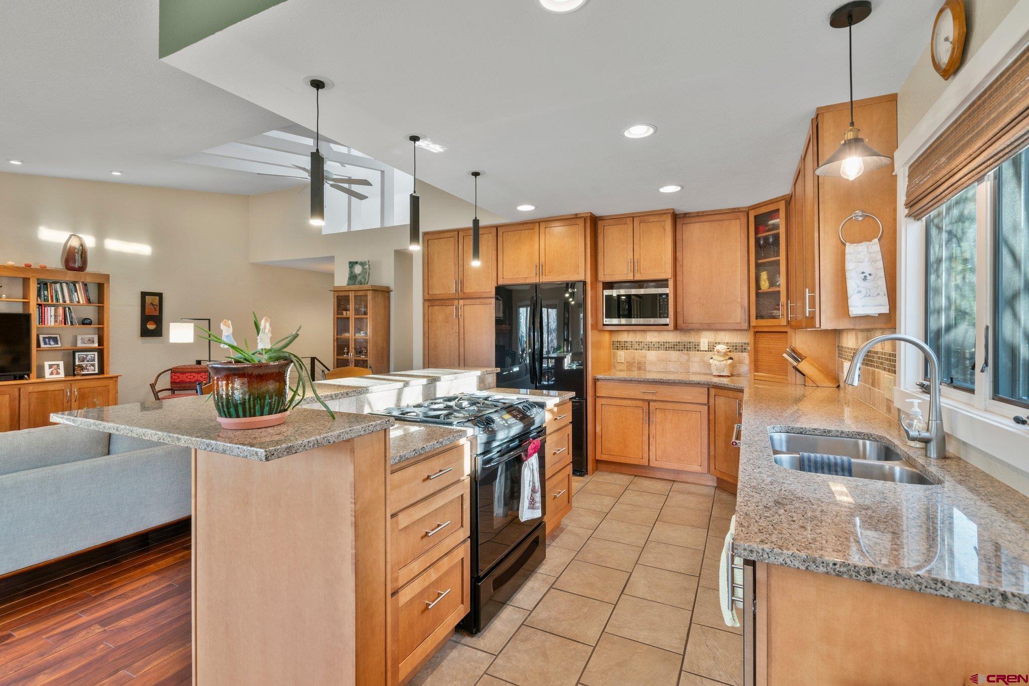 321 Pine Ridge Loop Durango, CO 81301 - Photo 8 of 35 a kitchen with stainless steel appliances granite countertop a stove and a sink