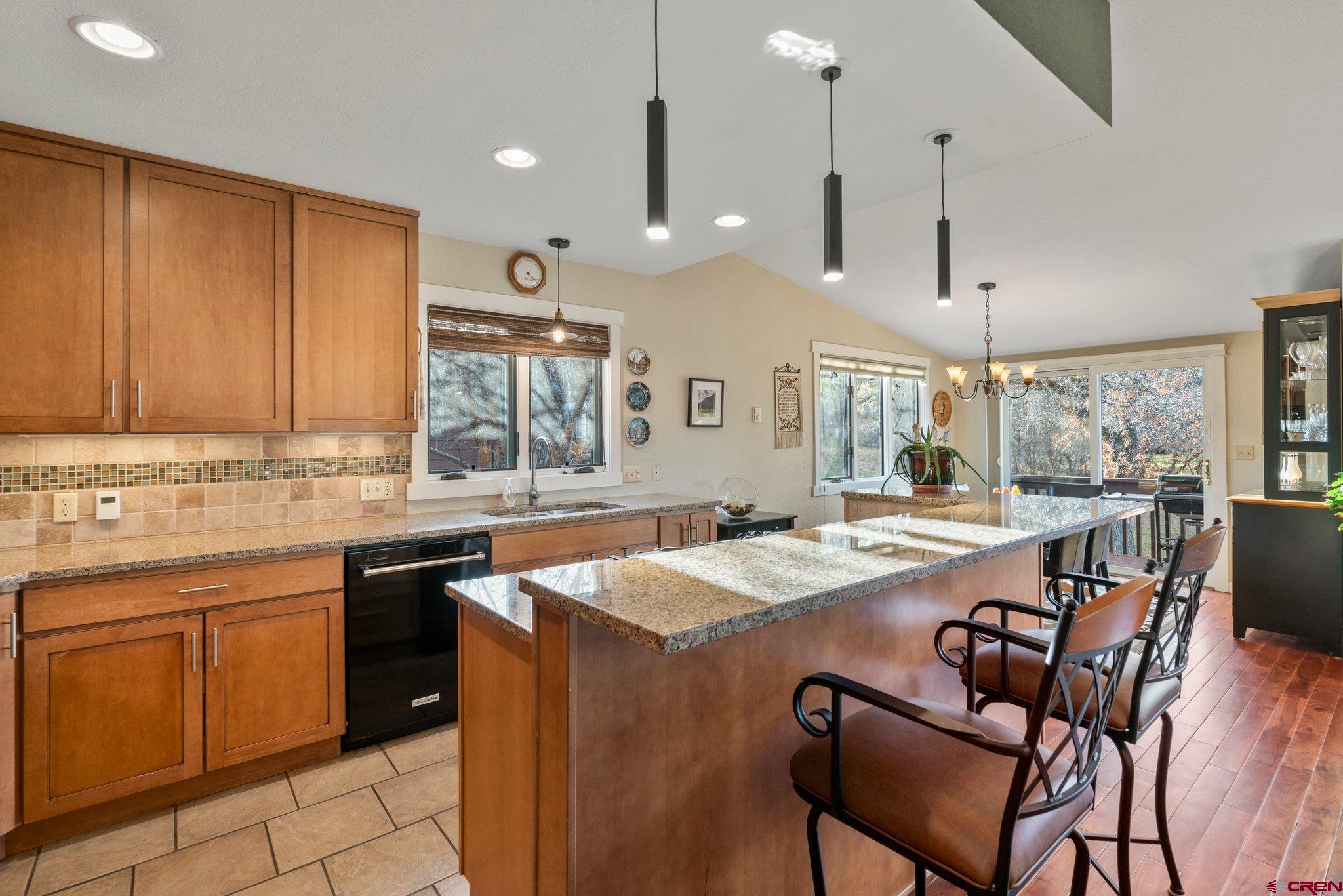 321 Pine Ridge Loop Durango, CO 81301 - Photo 9 of 35 a kitchen with a stove a sink a dining table and chairs