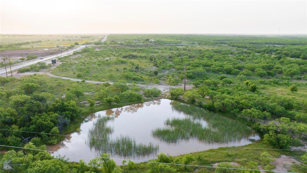 a view of a lake and green valley