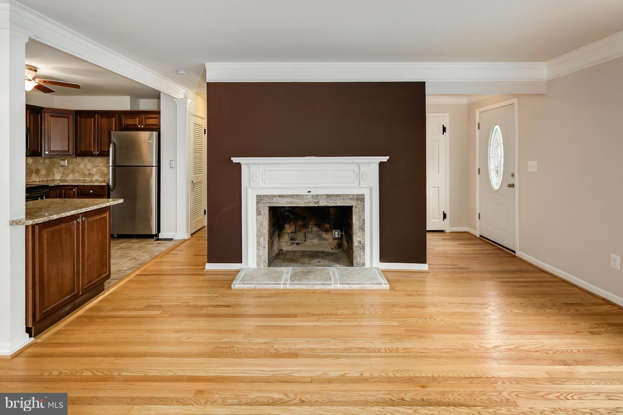 27110 Ridge Road Damascus, MD 20872 - Photo 4 of 30 a view of empty room with wooden floor and fireplace